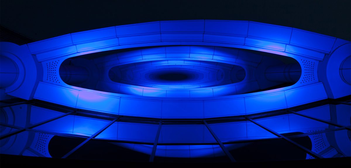 iconic hotel facade lit in dynamic colour at night